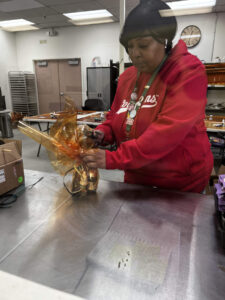 Employee from Production Department assempling the March Madness Bundles.